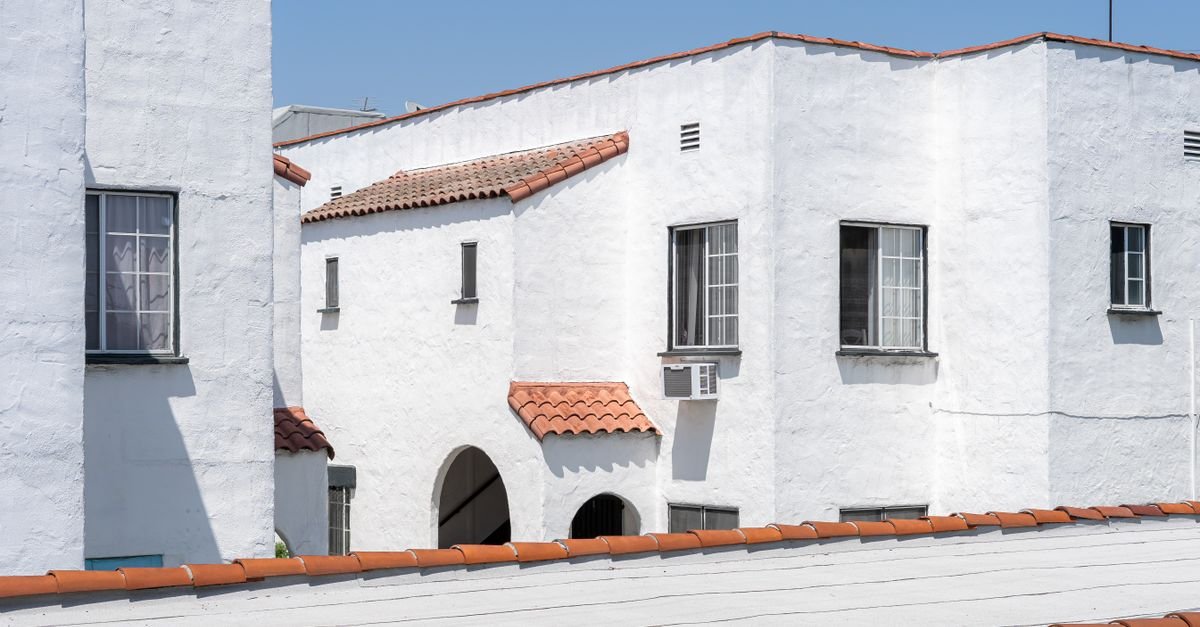 White stucco buildings with terracotta roofs under bright daylight