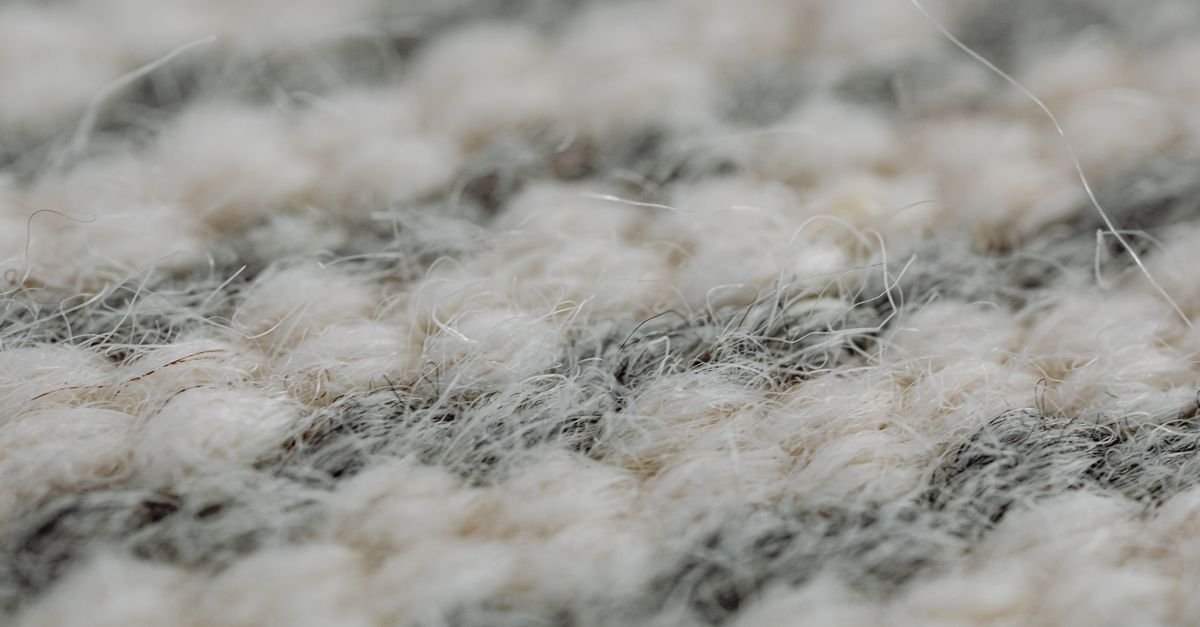 Close-up of a handmade wool rug showing dense pile and hand-knotted weave