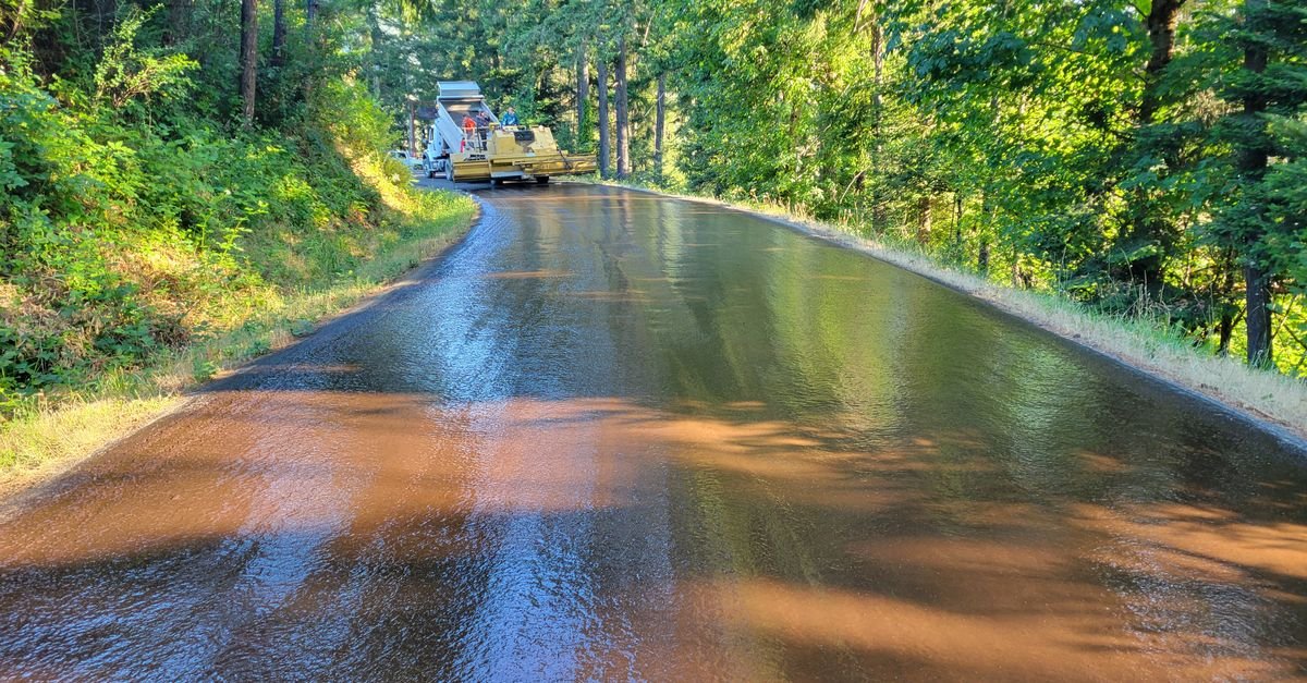 Freshly paved black asphalt surface still curing