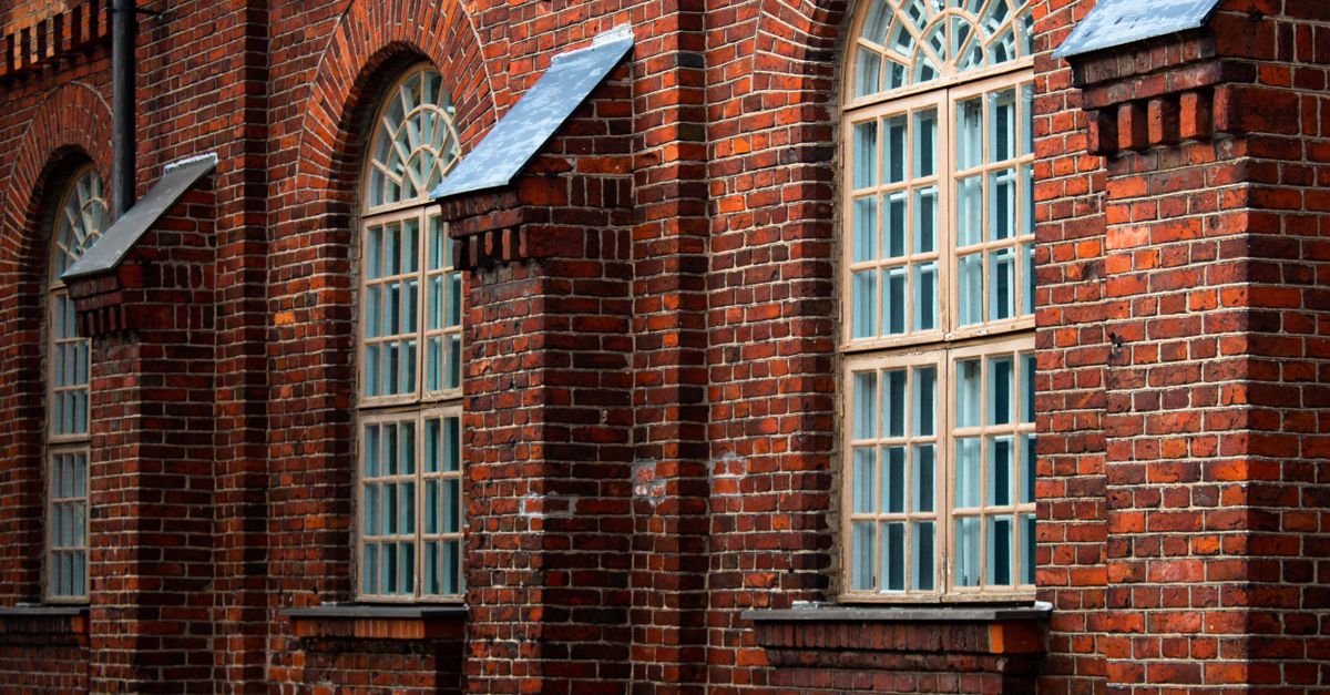 Historic brick building facade with arched windows and ornate detailing