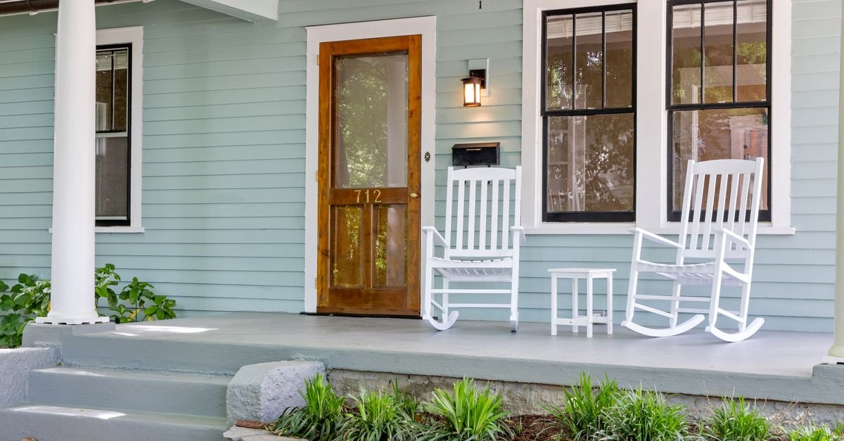 White painted wood rocking chairs on a porch