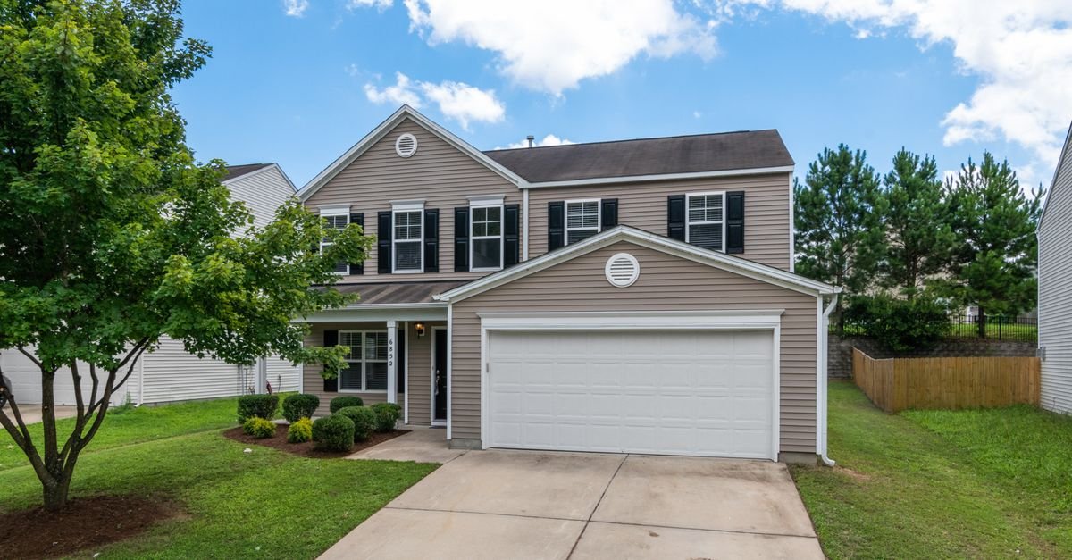 Two-story house with vinyl siding and a concrete driveway