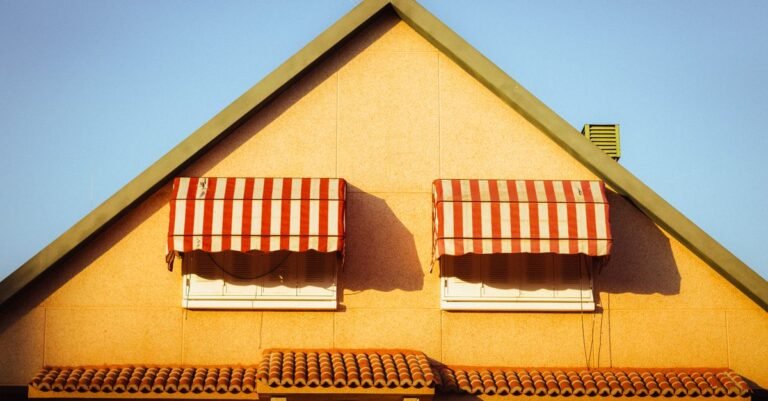 Close-up of a Spanish house in Madrid with red and white striped awnings under a clear sky