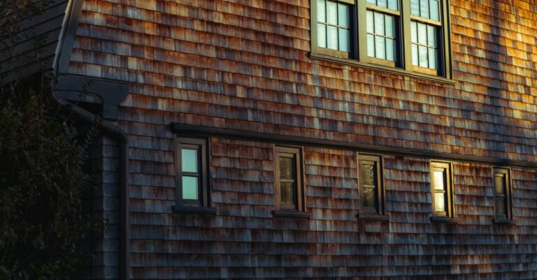 Evening sunlight across the cedar shingle facade of a coastal house