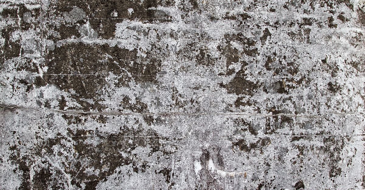 Close-up of a rough unsealed concrete surface showing its open pore texture