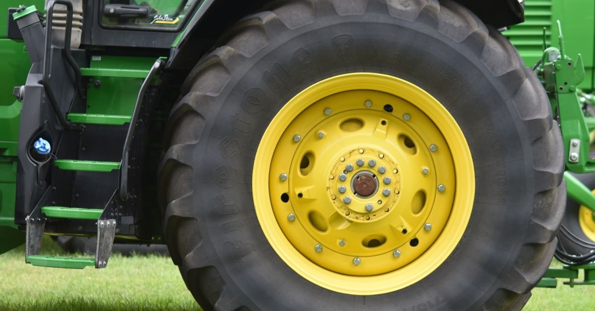 Close-up of a wheel and hub on a green agricultural tractor