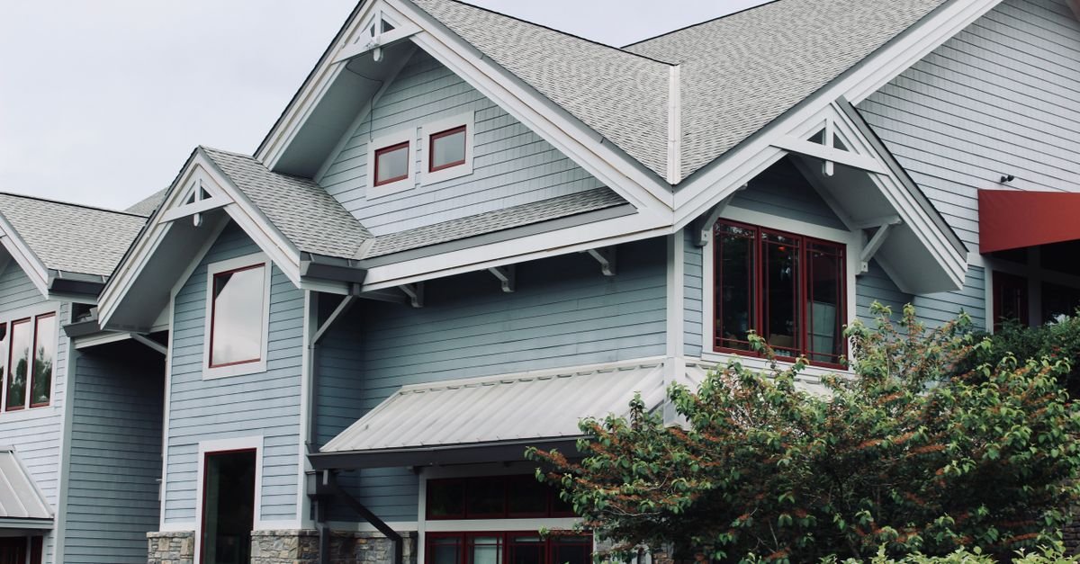 A blue-painted house exterior with horizontal lap boards and crisp white trim
