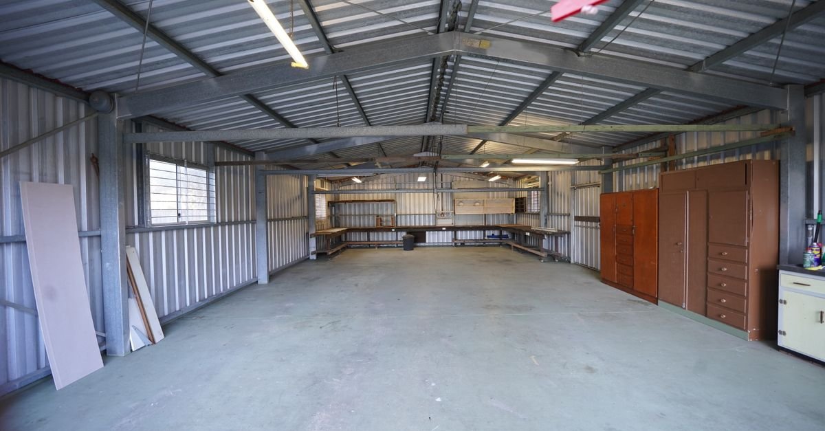 Empty garage bay with a clean dry concrete floor and the door shut