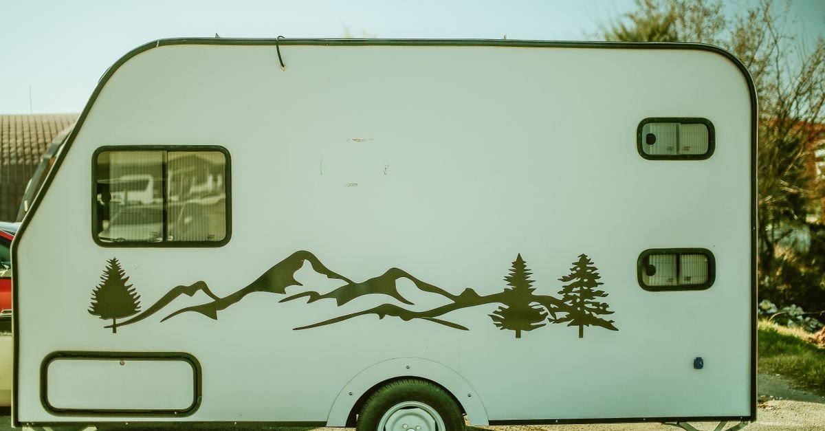 Retro travel trailer with a large mountain landscape decal on its side