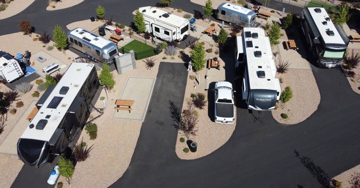 Aerial view of a modern RV park with the flat roofs of several campers and trailers visible