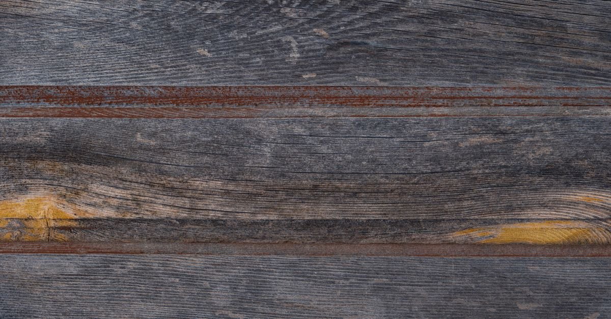 Close-up of aged lapped siding boards, each course overlapping the one beneath it
