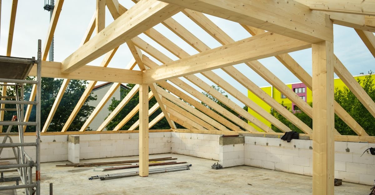 Open timber roof structure under construction, rafters landing on the wall head with the eave space still exposed
