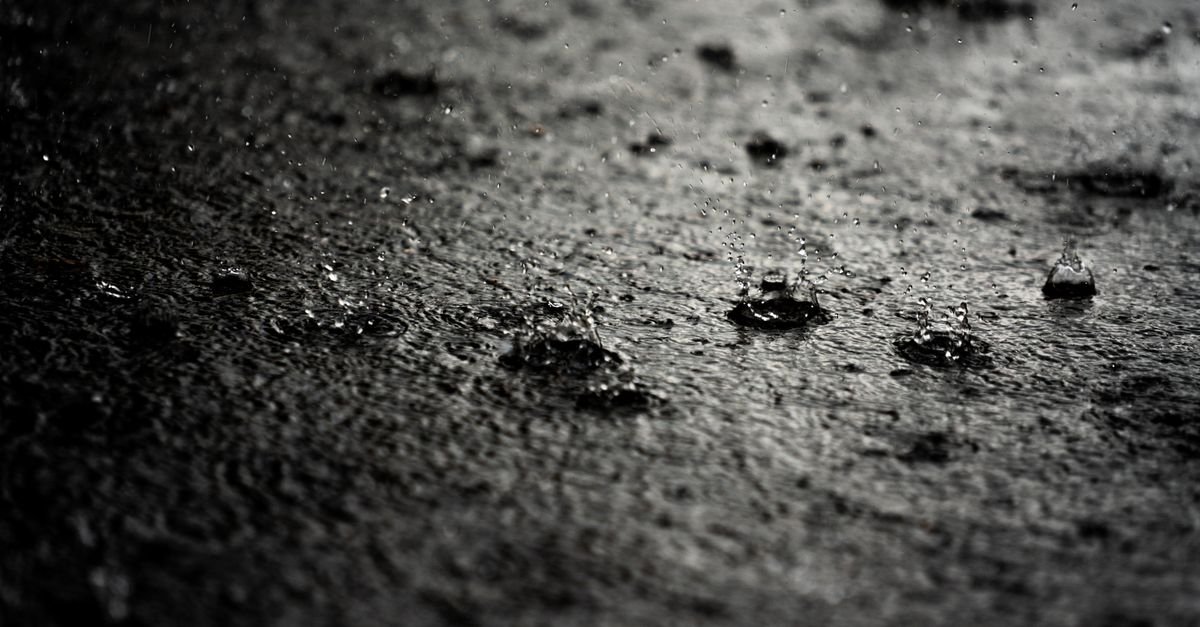 Water droplets sitting on a rough concrete surface during a spot test