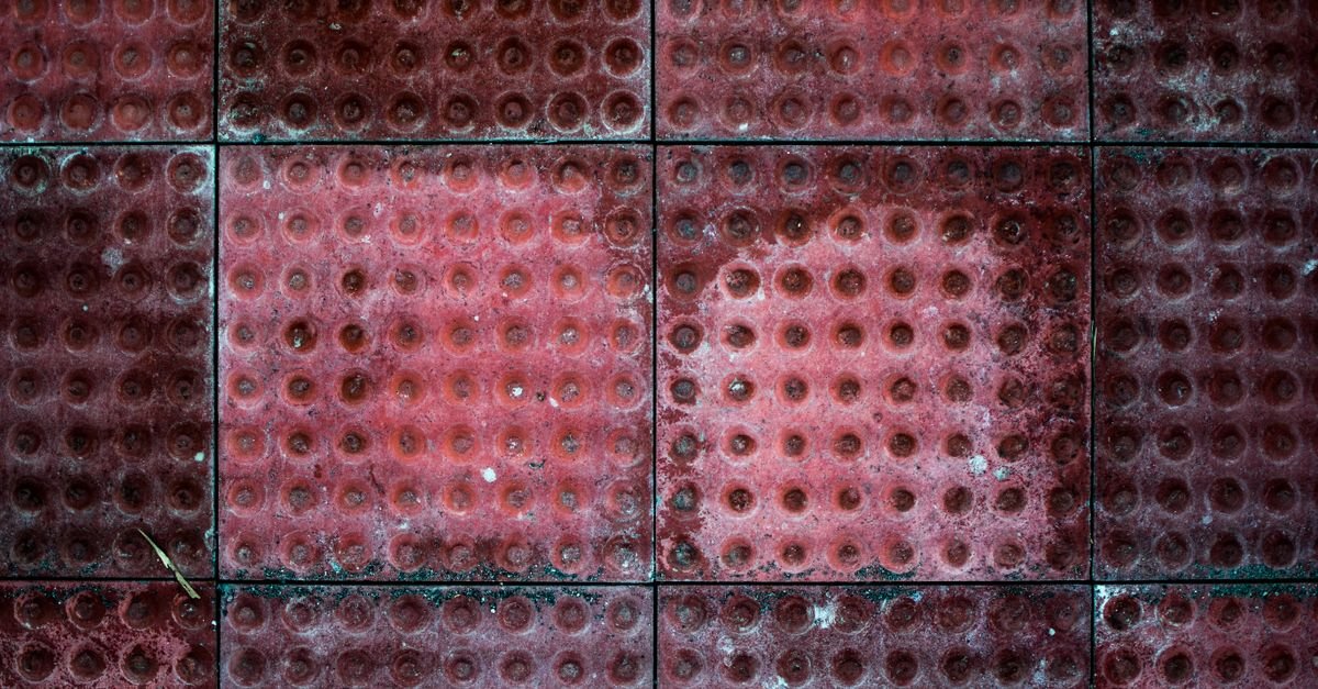 Patterned tiles showing faded colour and visible wear across the raised surfaces