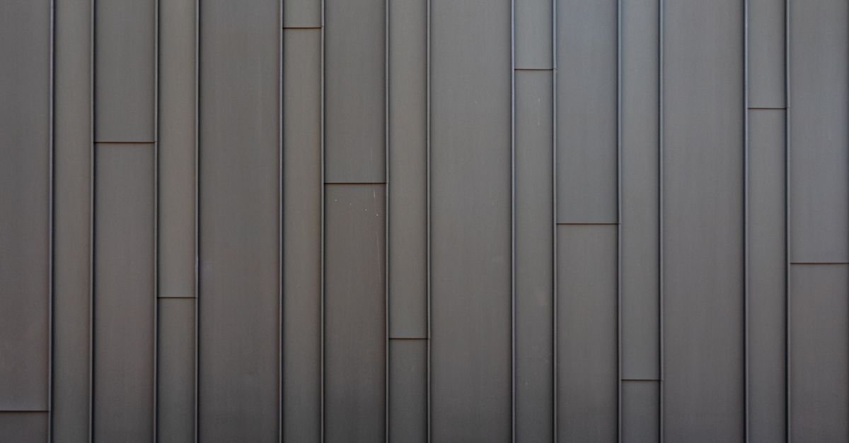 A sleek vertical steel panel wall with intact factory coating and clean seams