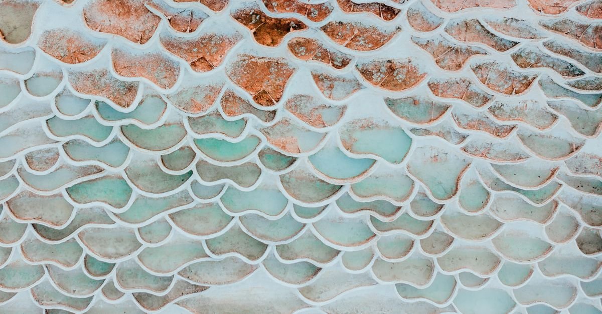 Layered travertine mineral deposits forming in the run-off of a hot spring
