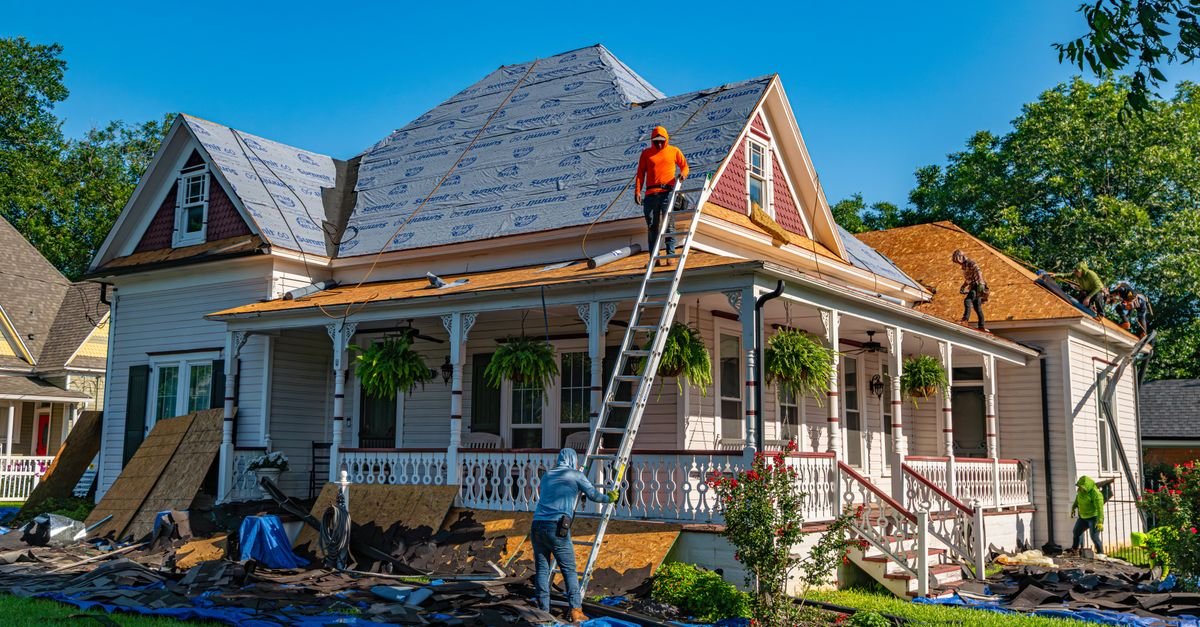 Roofers working on a house roof, concentrating foot traffic on individual tiles and lap edges