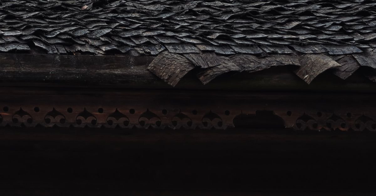 Close-up of a textured wooden shake roof, the natural material that synthetic composite shakes imitate