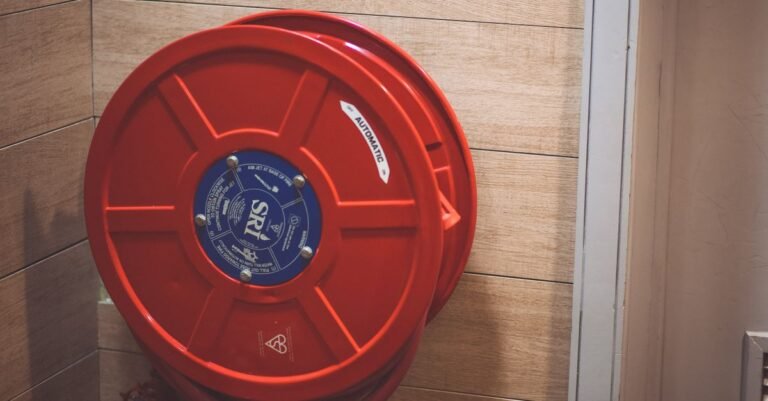 A wall-mounted hose reel with the hose wound flat and evenly across the drum