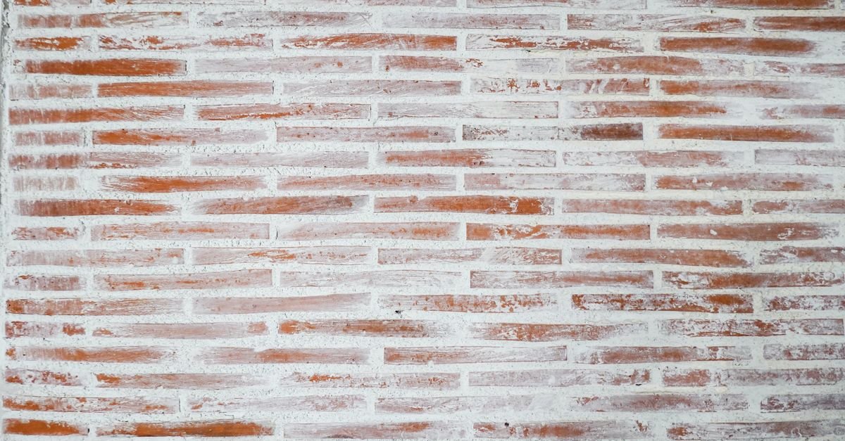 Red brick wall with wide pale mortar joints running between every course