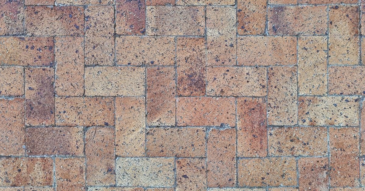 Herringbone-pattern brick pavers with sand joints that can be disturbed by high pressure
