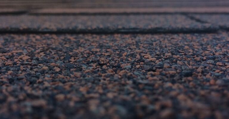 Close-up of asphalt shingle granules, the protective surface a pressure washer strips away