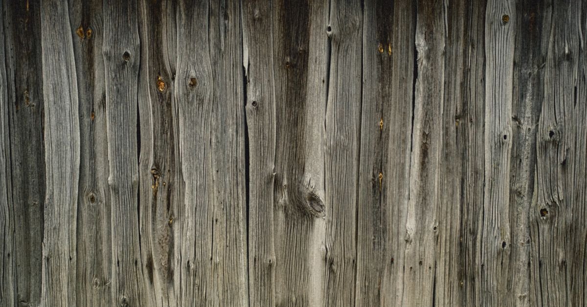 Silver-gray weathered wood fence boards showing UV weathering