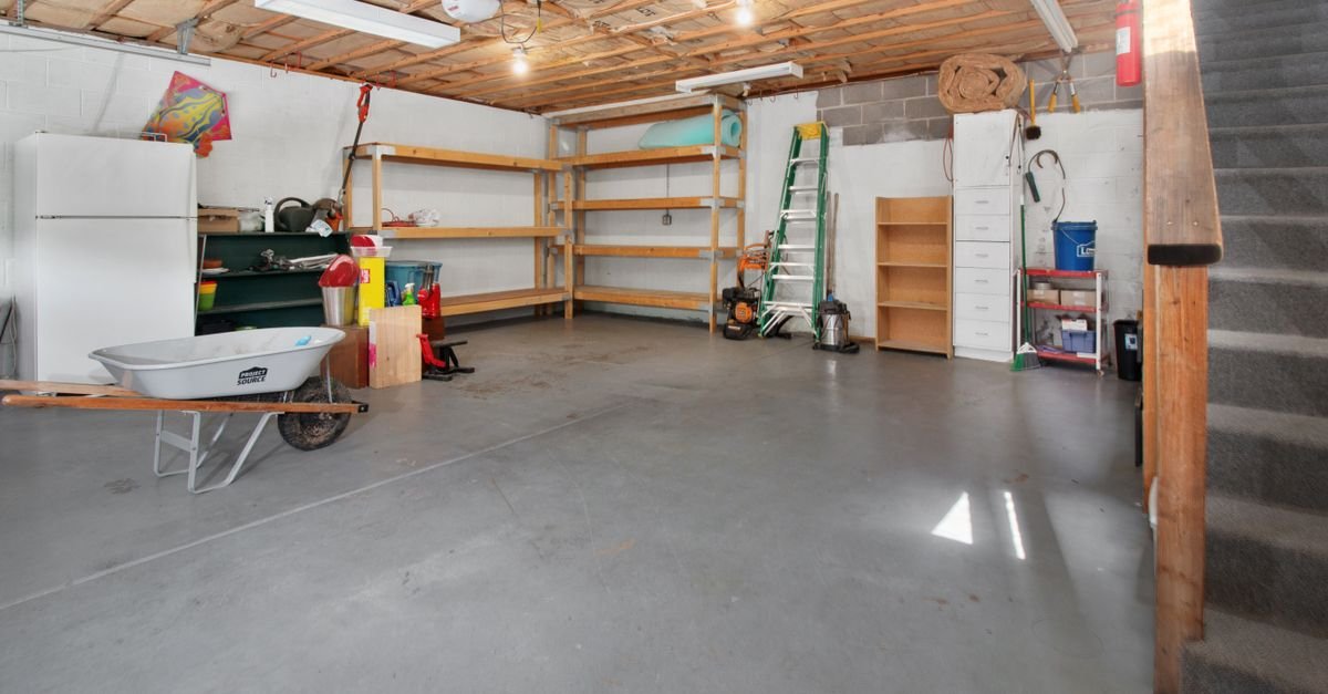 Tidy garage interior with storage shelving and tools where a jet washer can be stored dry
