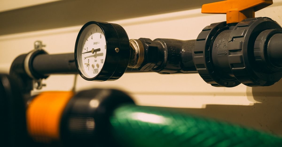 Close-up of a pressure gauge fitted to pipework, the only way to read what a pump is actually delivering