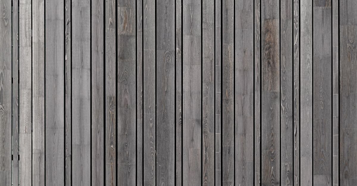 Grey weathered timber planks with open grain, the surface an oxygen bleach wash is meant to brighten