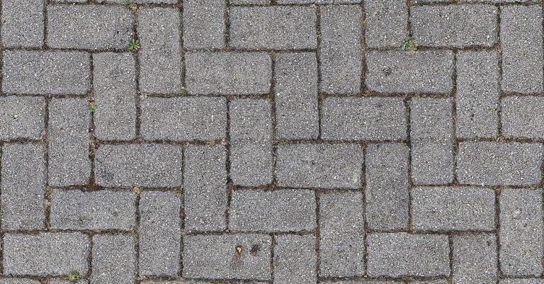 Close-up of interlocking grey concrete pavers with narrow sand-filled joints