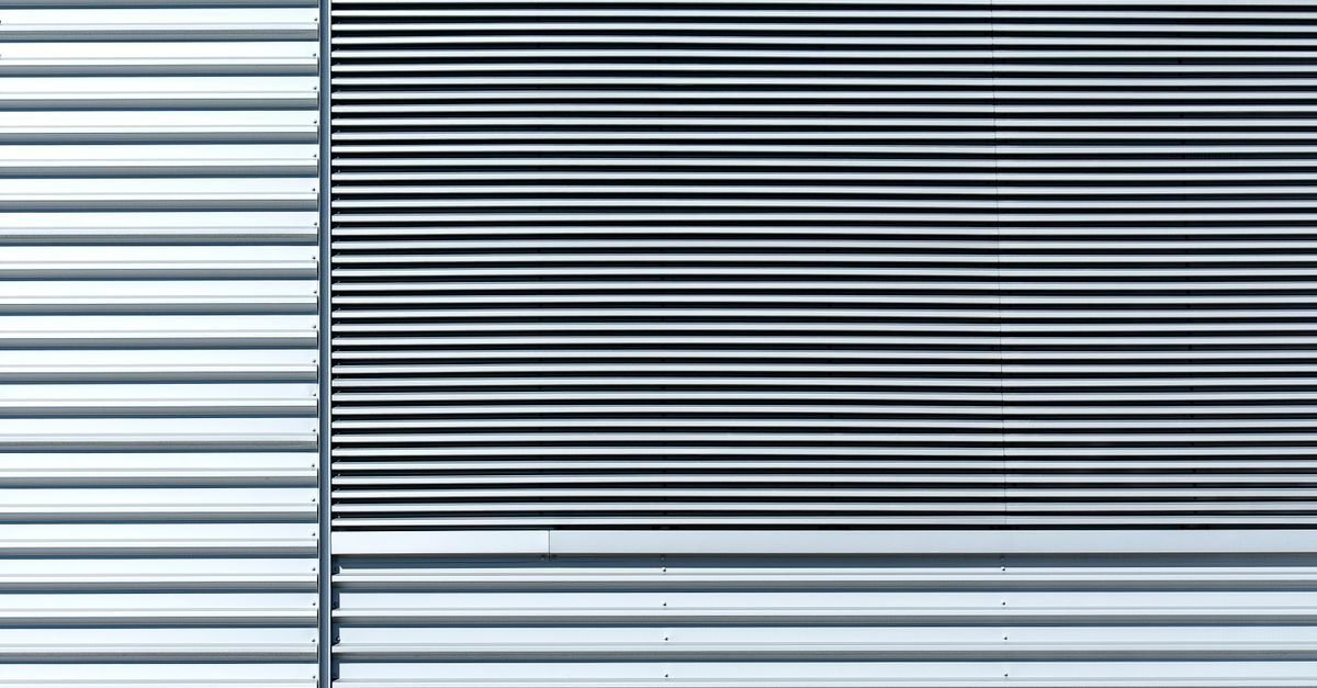 Close-up of an aluminium clad wall with horizontal panel lines and a metallic finish