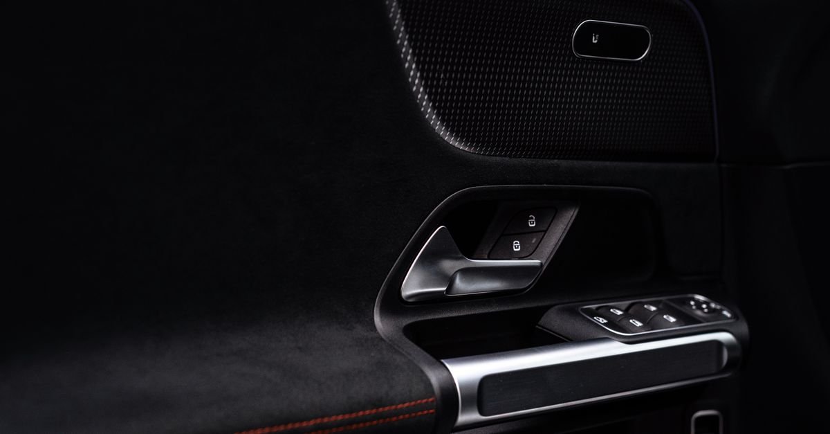 Modern car door panel with window switches and integrated speaker