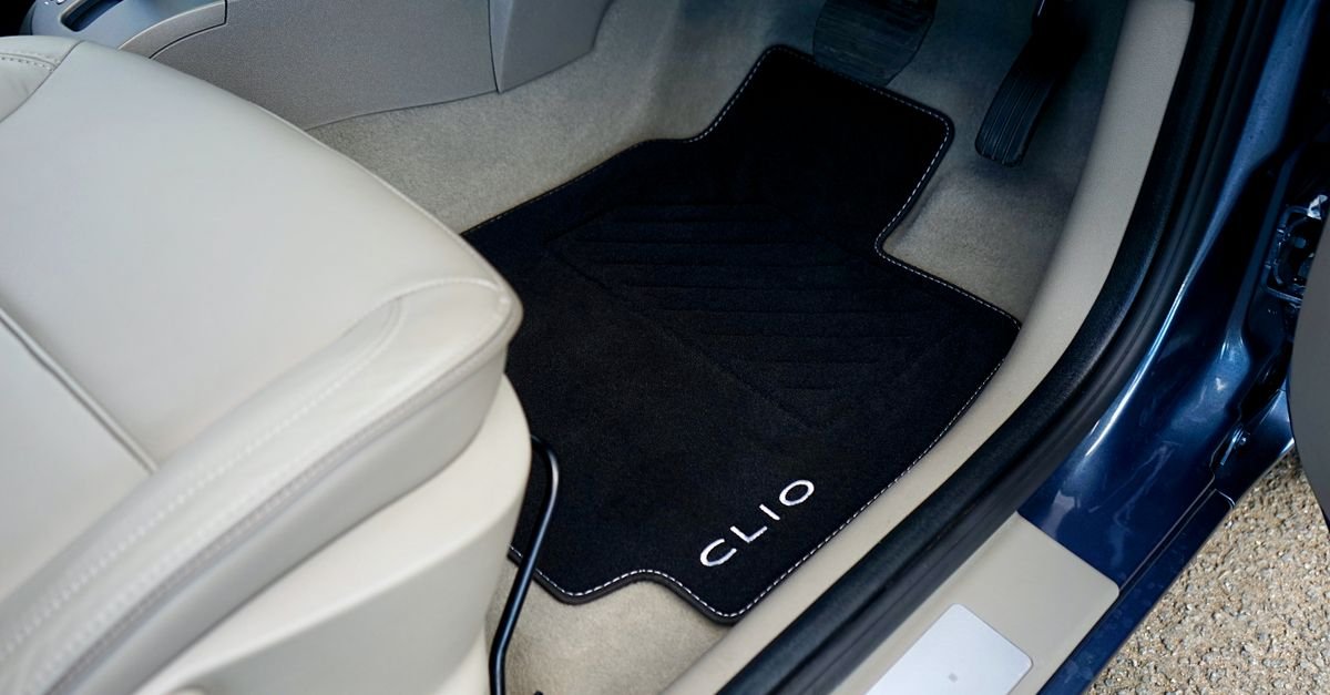 Moulded rubber car floor liner in a footwell before removal for cleaning