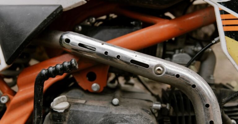Close-up of a single-cylinder petrol engine and its exhaust header and silencer