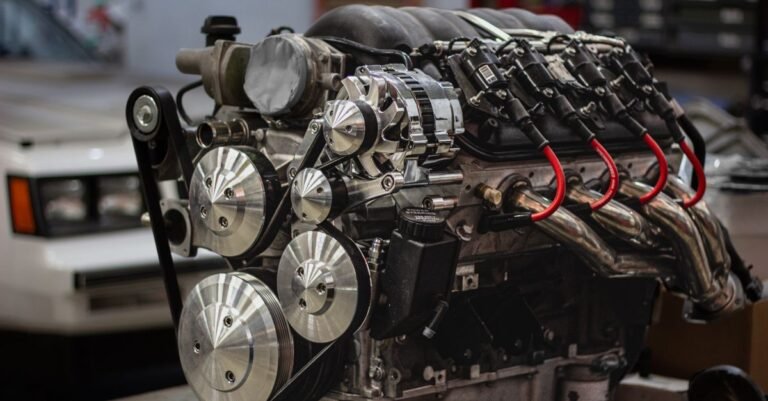 A drive belt wrapped around several smooth pulleys of different diameters on an engine, the arrangement a belt-drive pressure washer uses to turn its pump slower than the engine