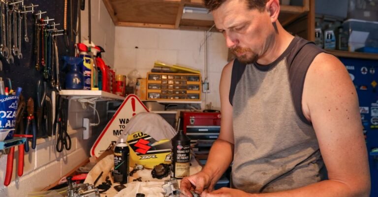 Mechanic working on a carburetor repair at a tidy garage workbench