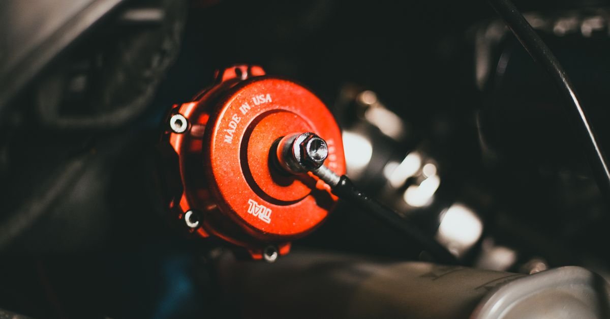 A poppet valve and seat inside an engine head, the same lift-and-seal geometry a pump check valve uses