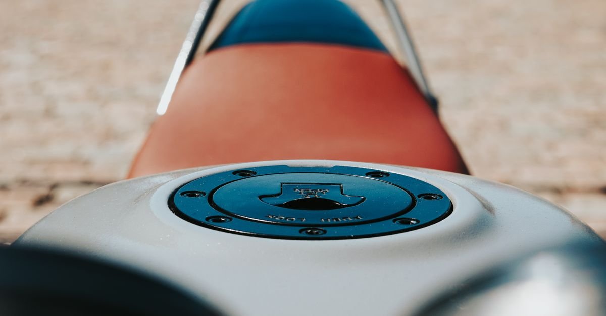 Close-up of a fuel tank cap, where a failed rim gasket or blocked vent lets fuel escape