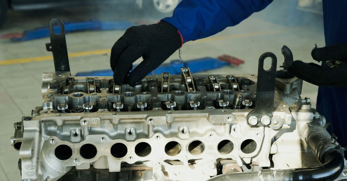 Inspecting a small petrol engine closely to find where fuel is escaping