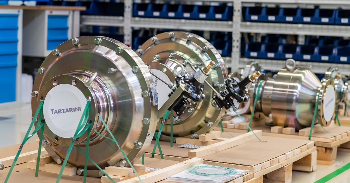 Row of large metal valve bodies stored on a workshop rack, the kind of serviceable internals a rebuild kit replaces