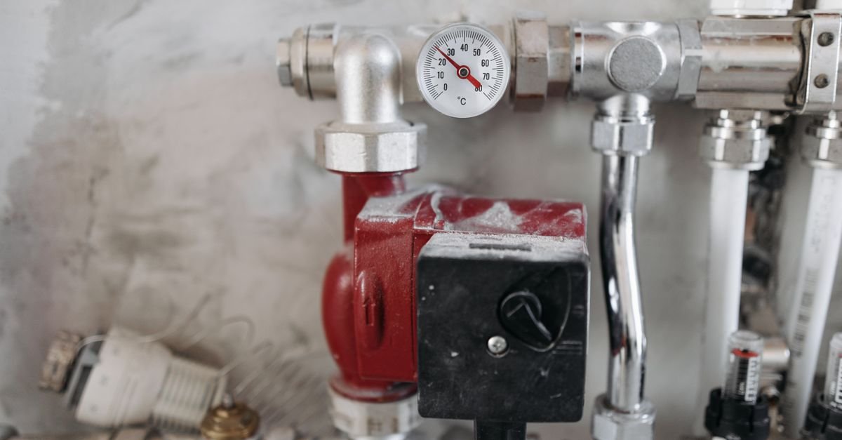 An industrial pressure gauge mounted on steel pipework, the instrument that settles whether a pump is actually building pressure