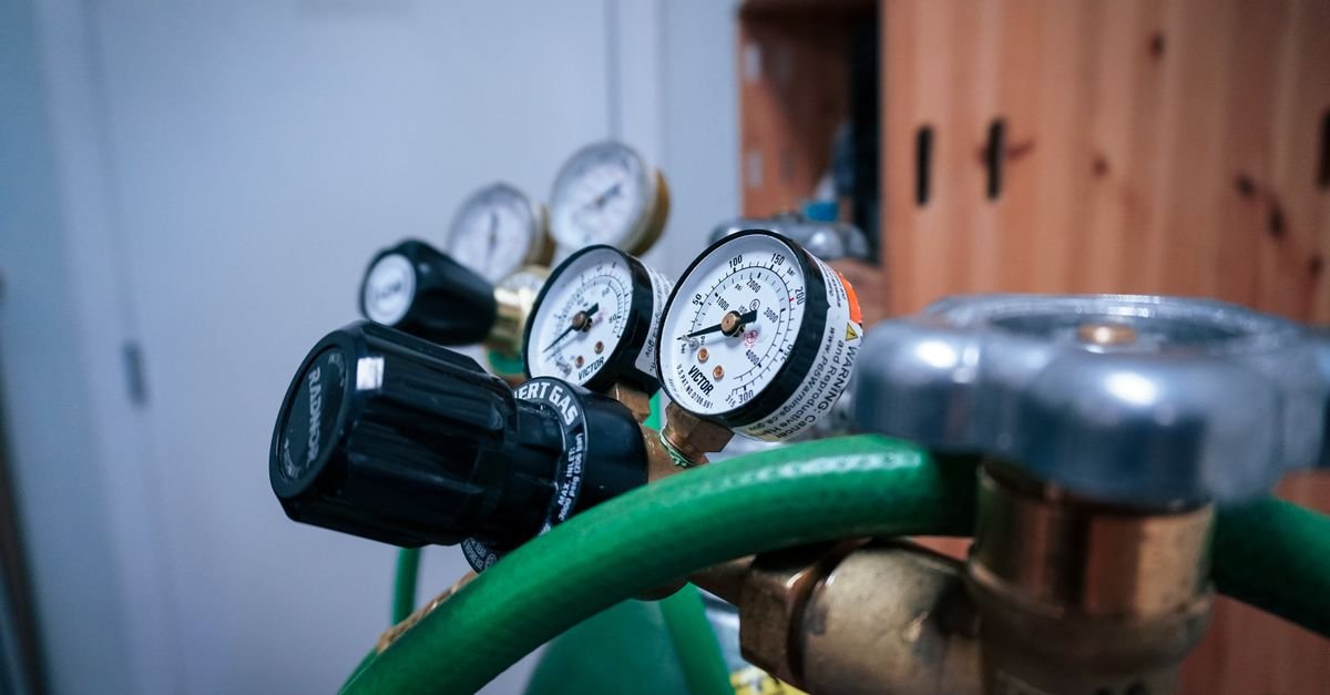 Industrial pressure gauges mounted on equipment, showing the working pressure a hose assembly is rated to carry