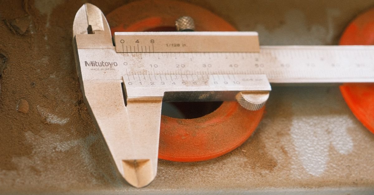 Vernier calipers on a workshop surface, the tool used to measure an O-ring groove accurately