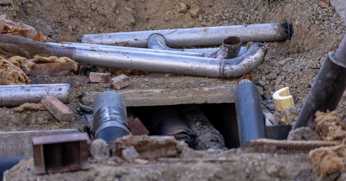 Newly installed water pipework at a construction site, the kind of mains work that puts a slug of sediment into a supply line