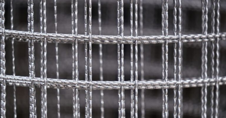 Macro view of fine woven stainless wire mesh, the same screen structure used in a pressure washer inlet filter