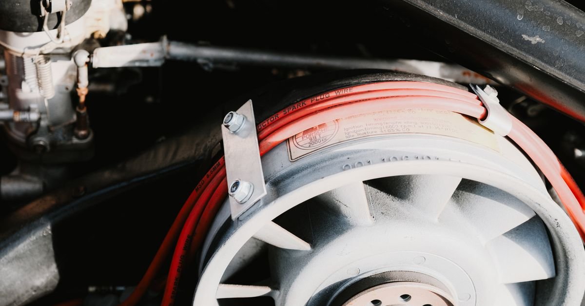 Automotive engine components with visible wiring, the kind of single-wire run a low oil sensor uses