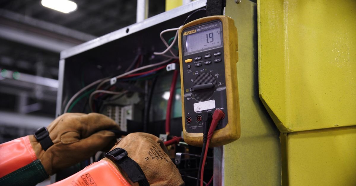 An electrician using a multimeter on an electrical panel, the level of equipment this repair actually needs