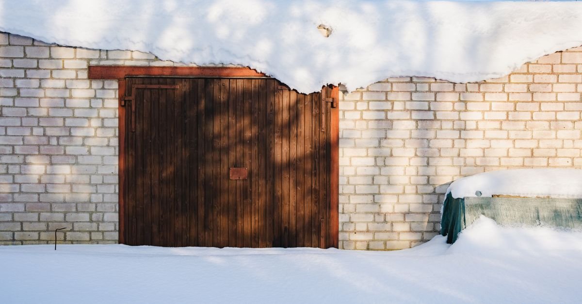 A snow-covered brick garage in winter, where most seized pressure washer pumps are made