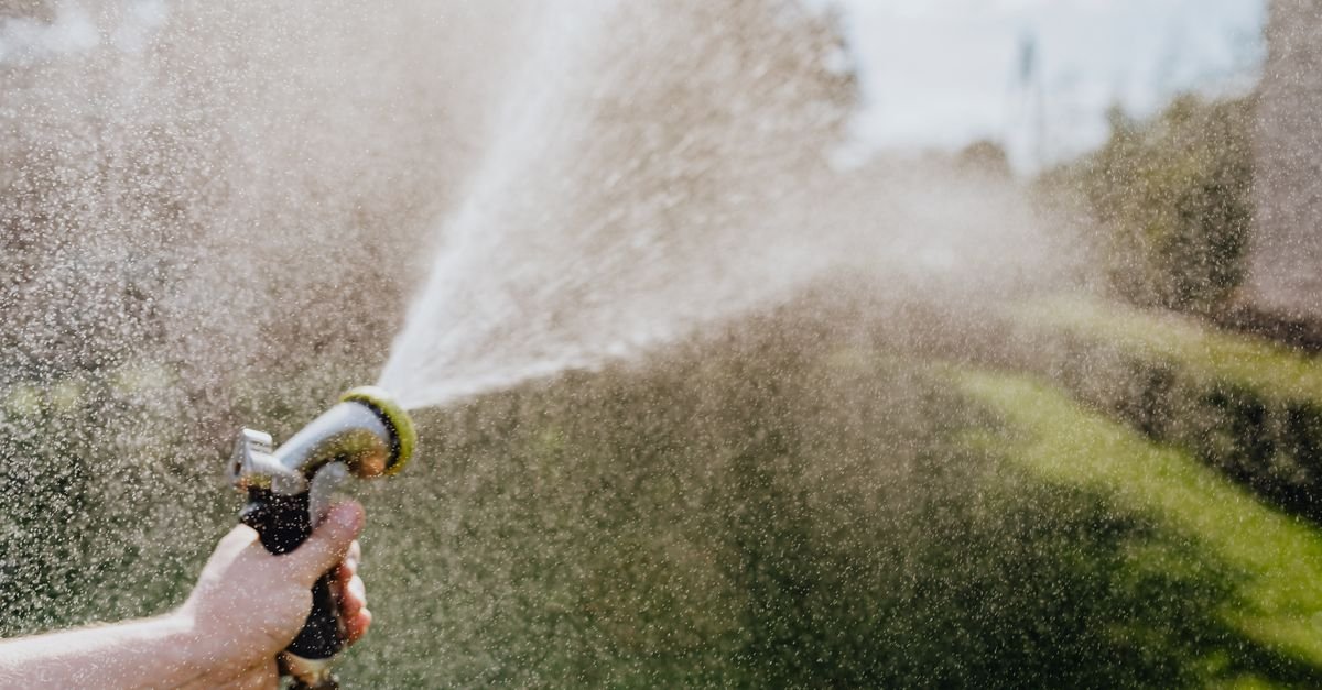A garden hose running at full flow, the supply a pressure washer pump depends on to stay cool